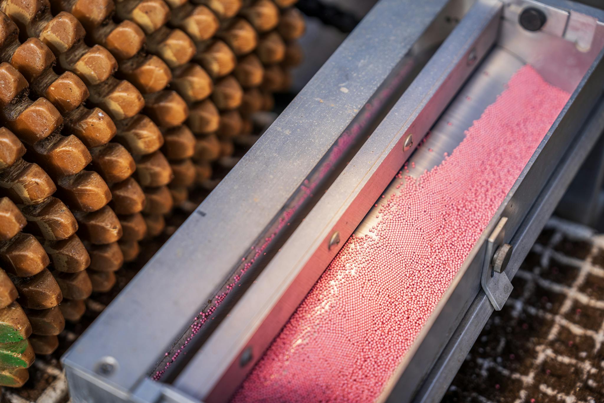 Close-up of industrial machinery with pink ball bearings and metal equipment.