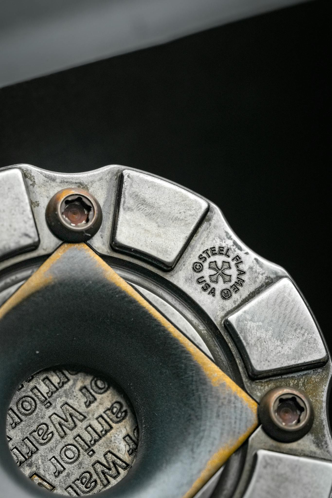 Detailed view of a steel industrial component with visible branding.